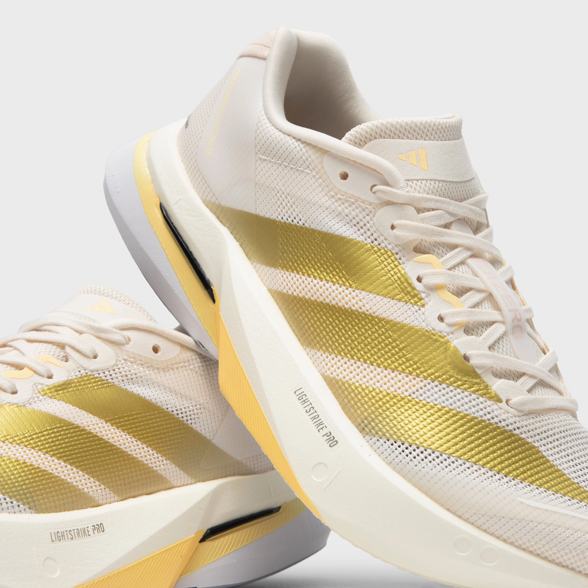 Gusseted Tongue Design Unique grip adidas Women's Adizero Boston 13 Chalk White / Gold Metallic - Orange Tint